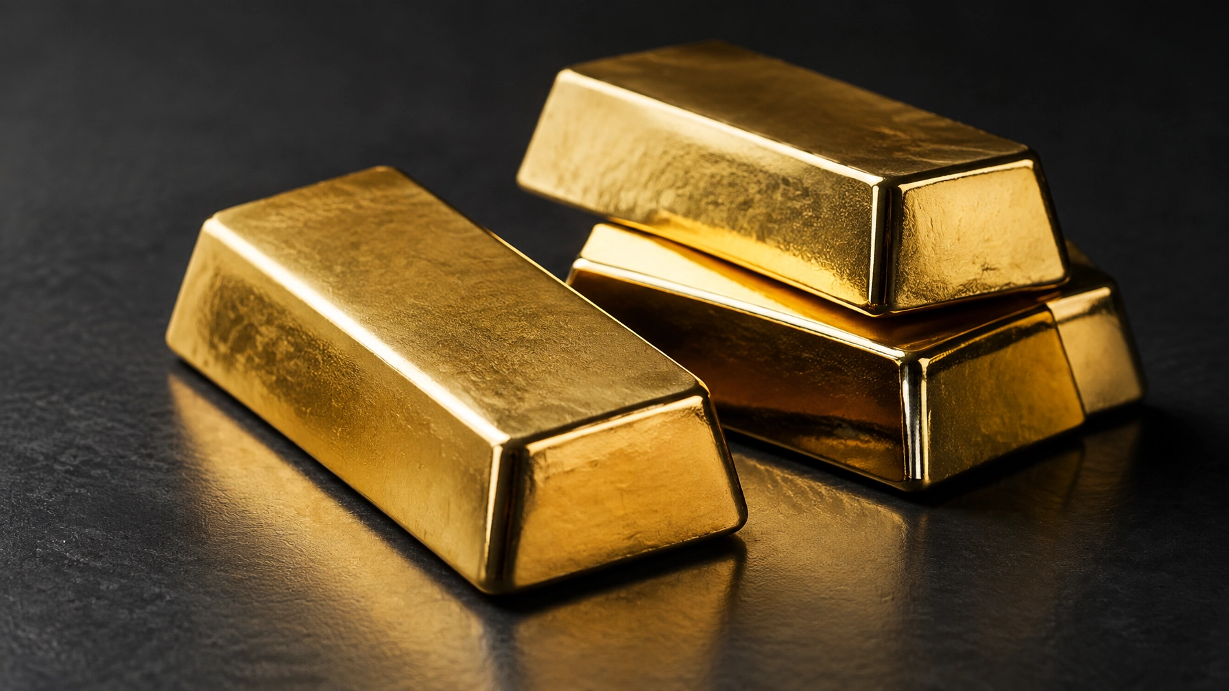 Gold bullion on a dark matte surface — Should I Invest in Gold?